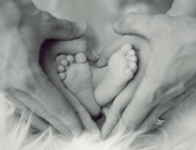 grayscale-photo-of-baby-feet-with-father-and-mother-hands-in-733881